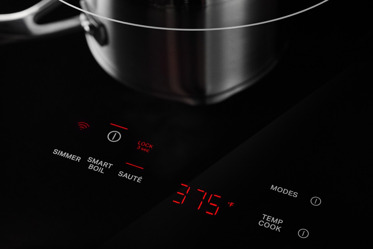 A pot sits on a burner on a Whirlpool cooktop. The range is set to 375 degrees.