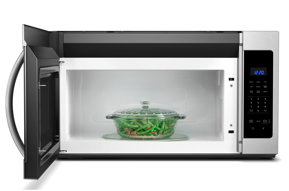 An opened Whirlpool Microwave with a lidded casserole dish of green beans