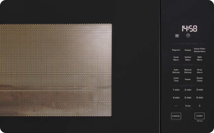 Un four à micro-ondes Whirlpool en train de cuire des aliments. L'heure indique : « 14:58 »