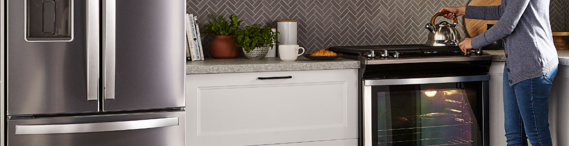 woman using Whirlpool range. 