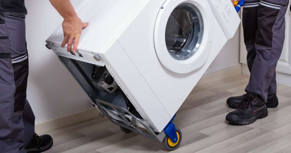 Two men removing an appliance from a home.