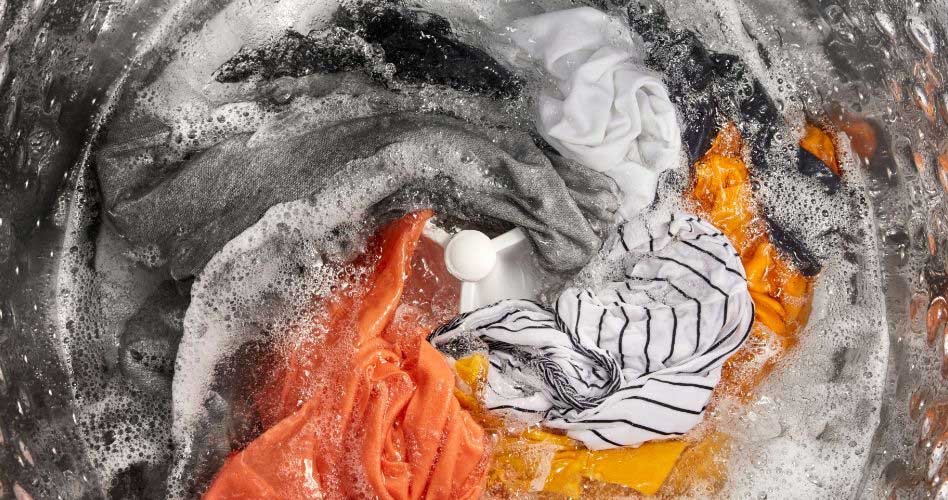 Clothes in the middle of a wash cycle in a Whirlpool washing machine.