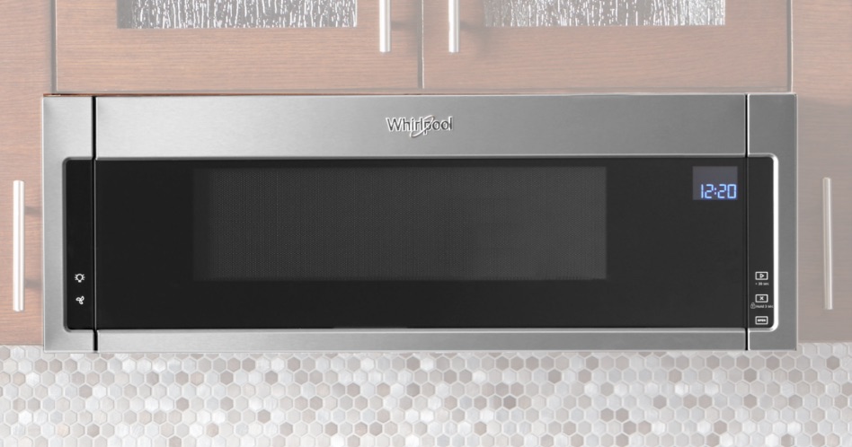 Whirlpool Combination Microwave An undercabinet microwave vent with a hood. The above cabinets are wood with glass windows and silver handles