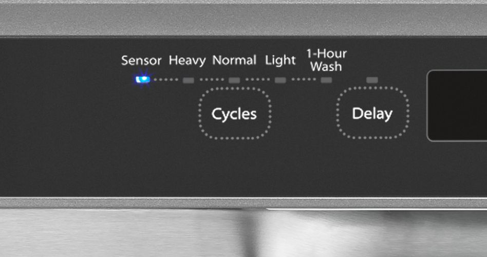 The control panel on a Whirlpool dishwasher. The sensor light is on. The other control are "Heavy", "Normal", "Light" and "1-Hour Wash". There are two buttons underneath: ""Cycles" and "Delays"