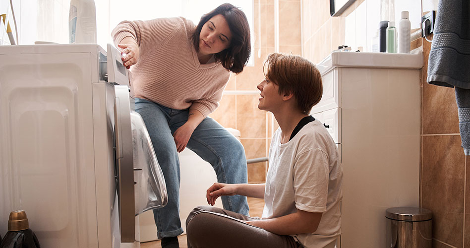 Two home owners using a dryer