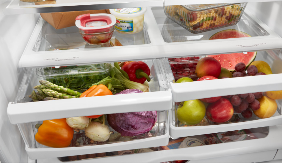 Whirlpool Combination Microwave A variety of fruits and vegetables are seen inside the crisper drawers of a Whirlpool refrigerator