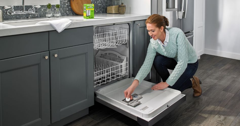 Whirlpool Combination Microwave Someone places an affresh pod in the detergent compartment in their Whirlpool dishwasher. A package of affresh cleaner is on the counter next to the sink. The kitchen has a Whirlpool fridge and grey cabinets.