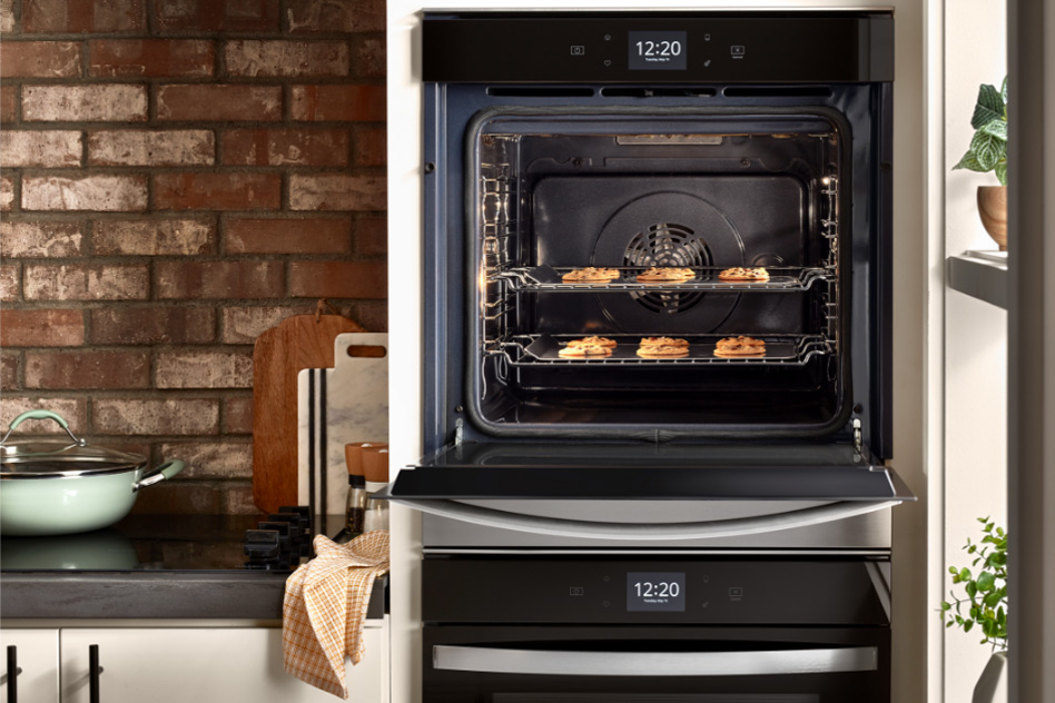 Whirlpool Combination Microwave An oven door is open featuring food items inside