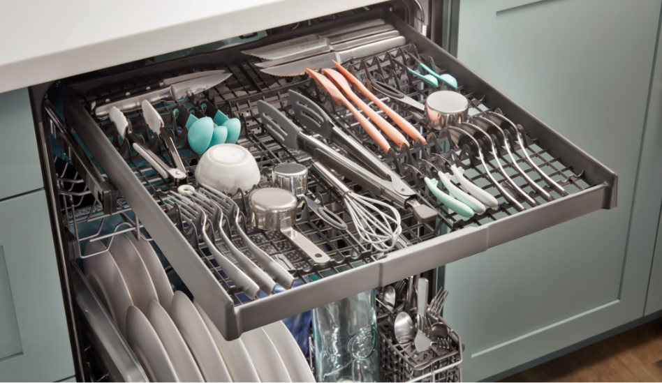 A close-up image of the third rack in a dishwasher filled with utensils and measuring cups.