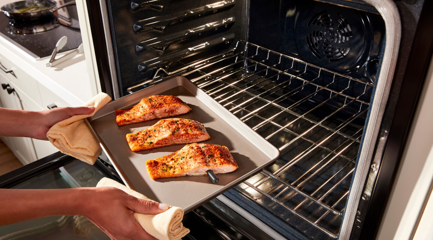 Putting salmon into the oven Putting salmon into the oven