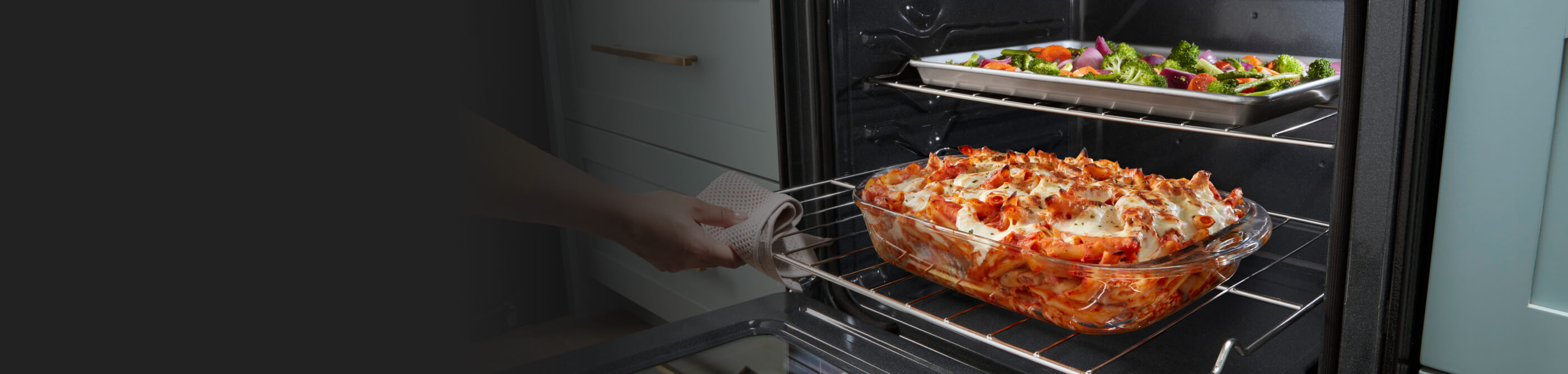 Baked ziti and vegetables inside an oven