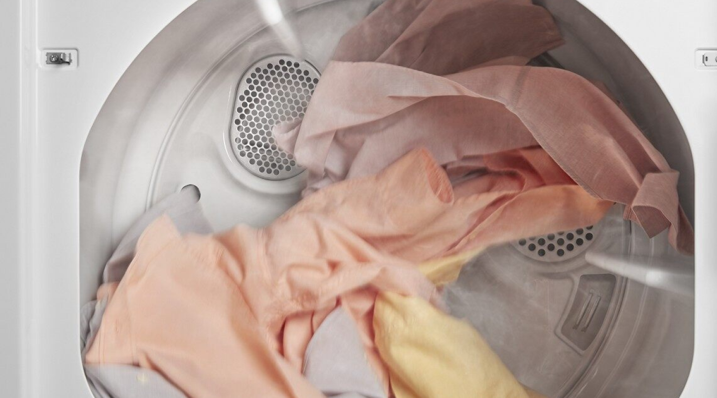 A closeup of laundry tumble drying in a Whirlpool® dryer.
