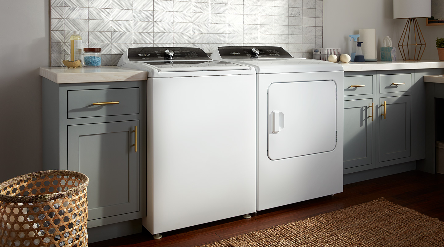 A white, matching top-load Whirlpool® Washer and Dryer