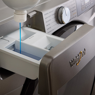 Detergent being loaded into a Whirlpool® Washer