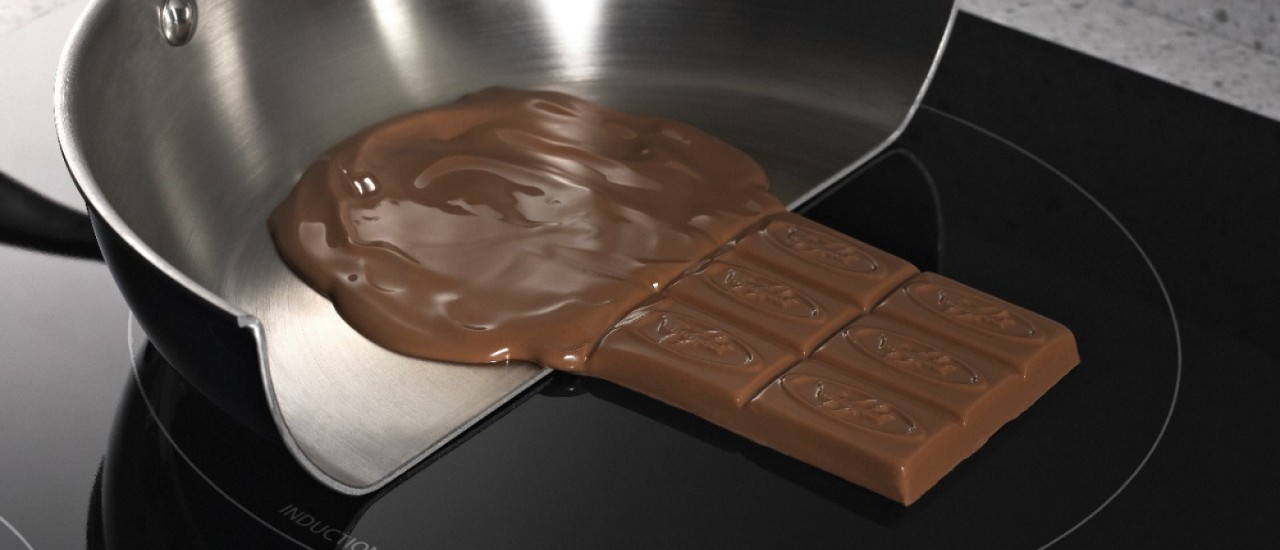 Chocolate melting in a pan and solid on an induction cooktop surface Chocolate melting in a pan and solid on an induction cooktop surface