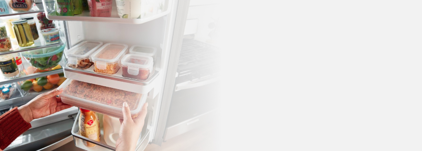 Person removing built-in storage containers from fridge