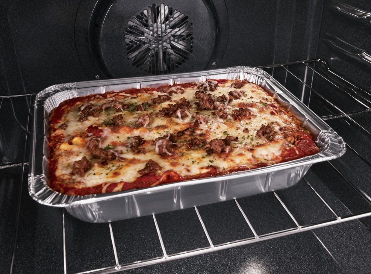  A tray of lasagna sits in an oven.