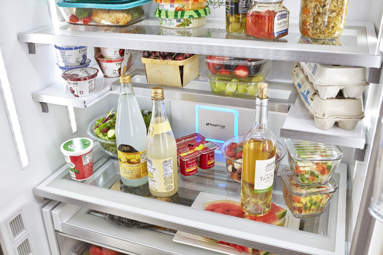 Refrigerator shelves stocked with various foods and beverages.