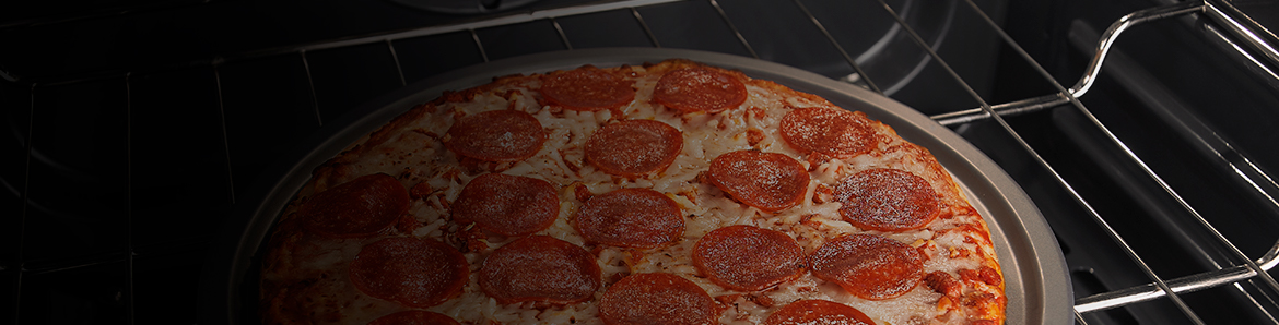 a pizza cooking in an oven
