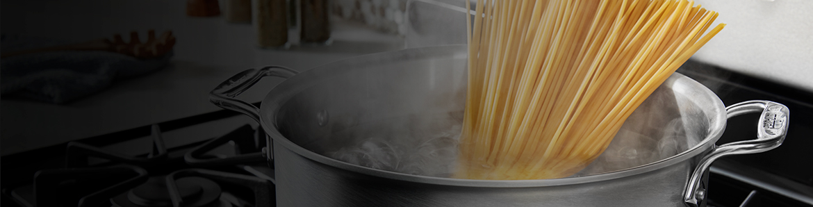 A pot of spaghetti on a stove
