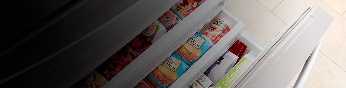 A multi-shelved freezer with food in it.