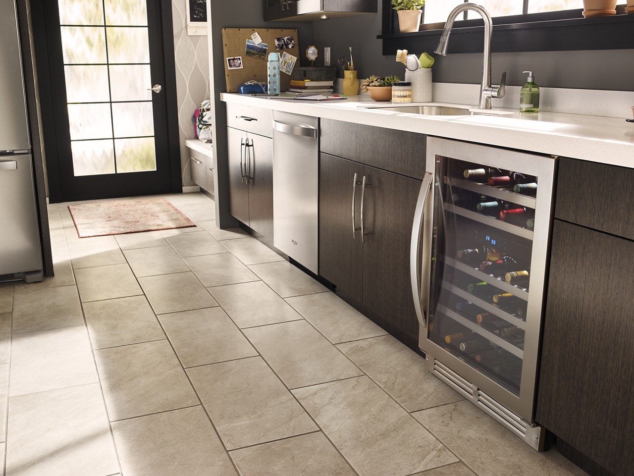 An undercounter wine refrigerator in a kitchen. An undercounter wine refrigerator in a kitchen.