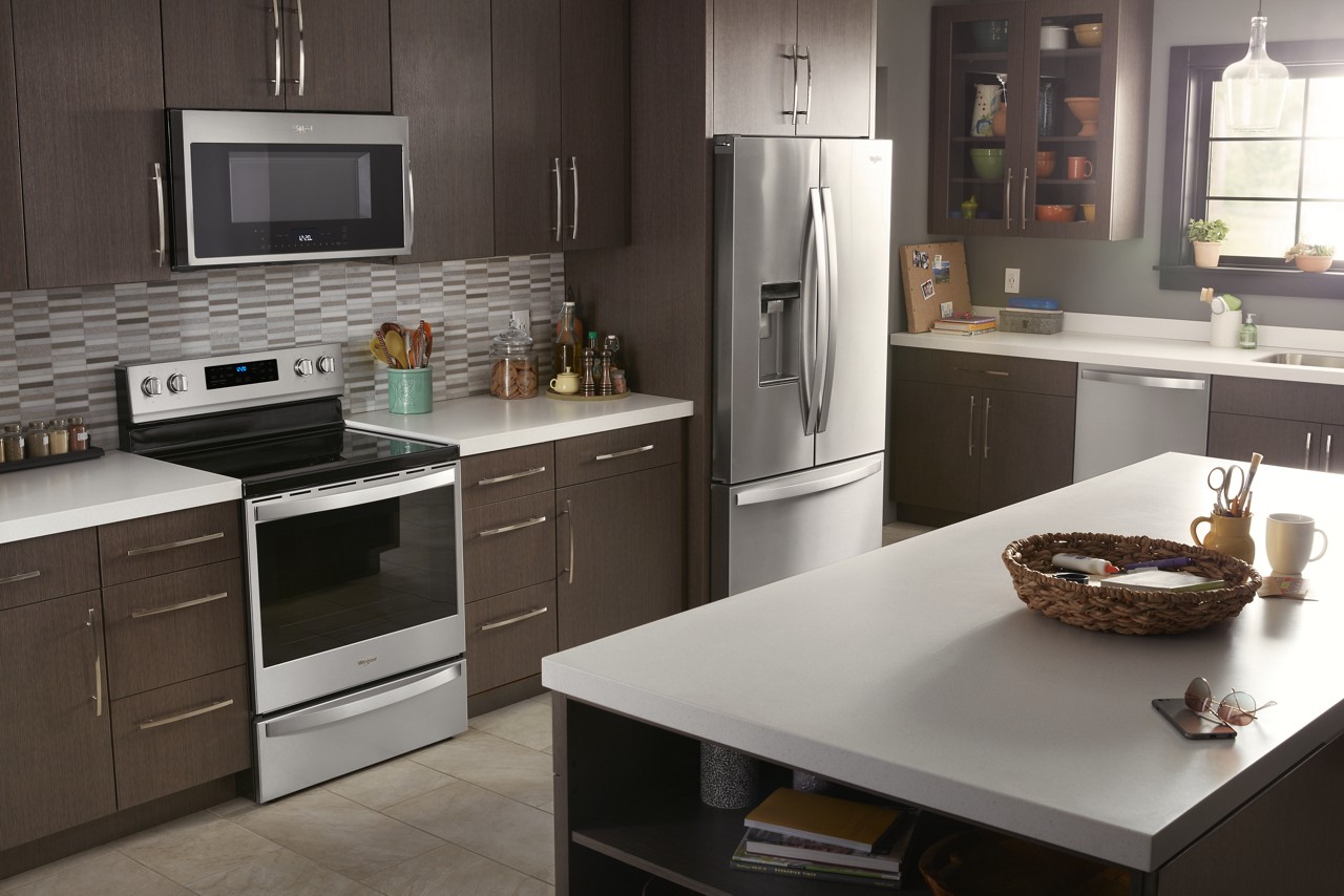 A stainless steel refrigerator in a kitchen A stainless steel refrigerator in a kitchen