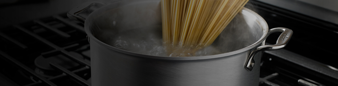 Pot of water boiling on the cooktop of a range