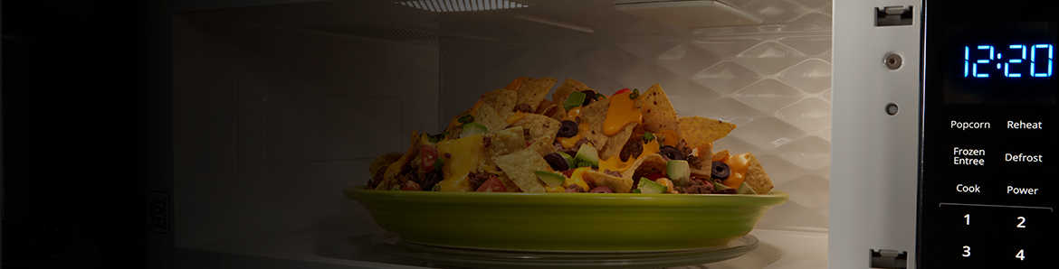 A plate of nachos in the microwave