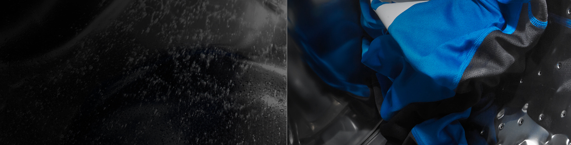 Close up image of water and garment in washing machine interior. 