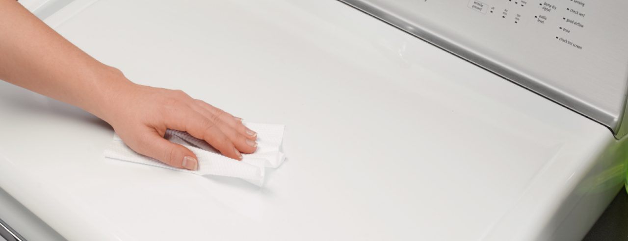 Women cleaning washing machine with wipe Women cleaning washing machine with wipe