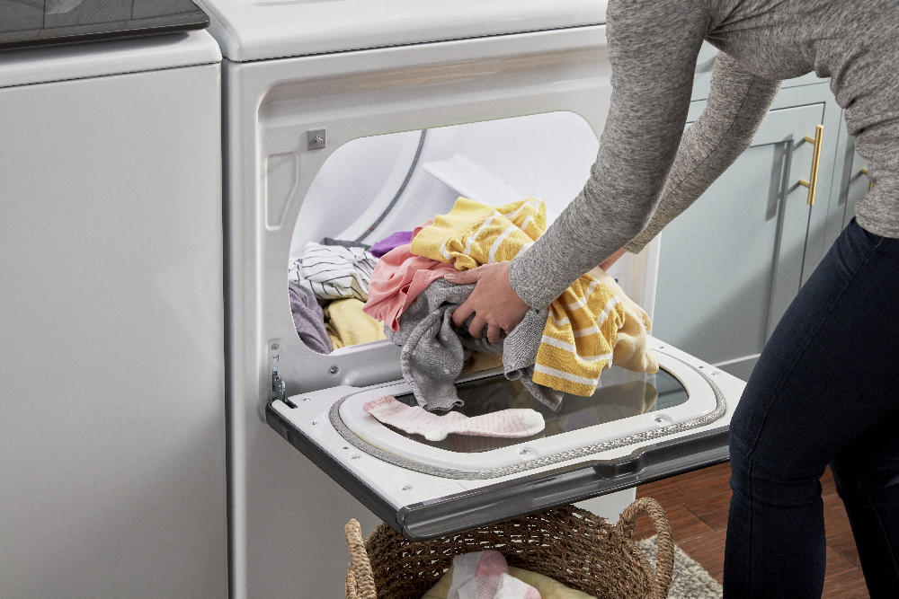 Unloading clothes from a Whirlpool dryer.