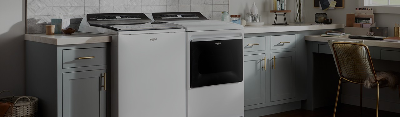Unloading clothes from a Whirlpool dryer. 	