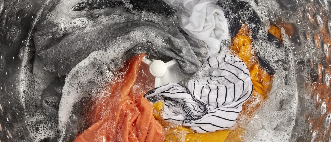 Clothes in soapy water at bottom of wash tub Clothes in soapy water at bottom of wash tub