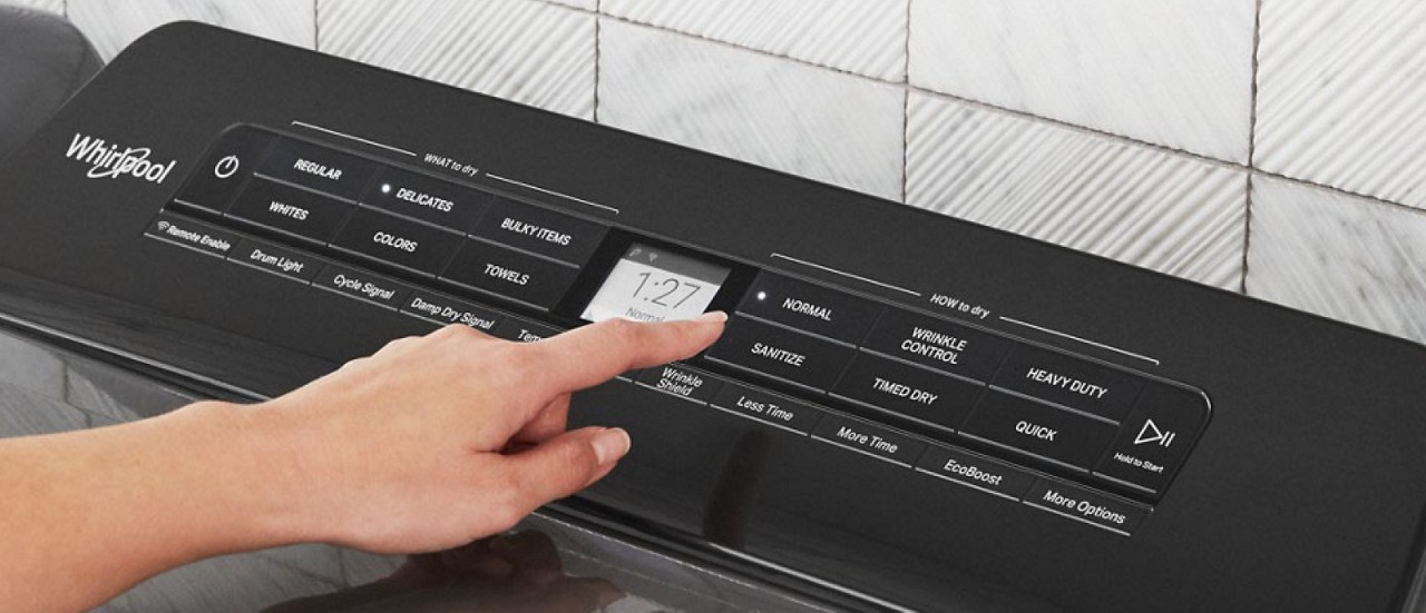 Hand selecting Normal cycle on dryer console Hand selecting Normal cycle on dryer console