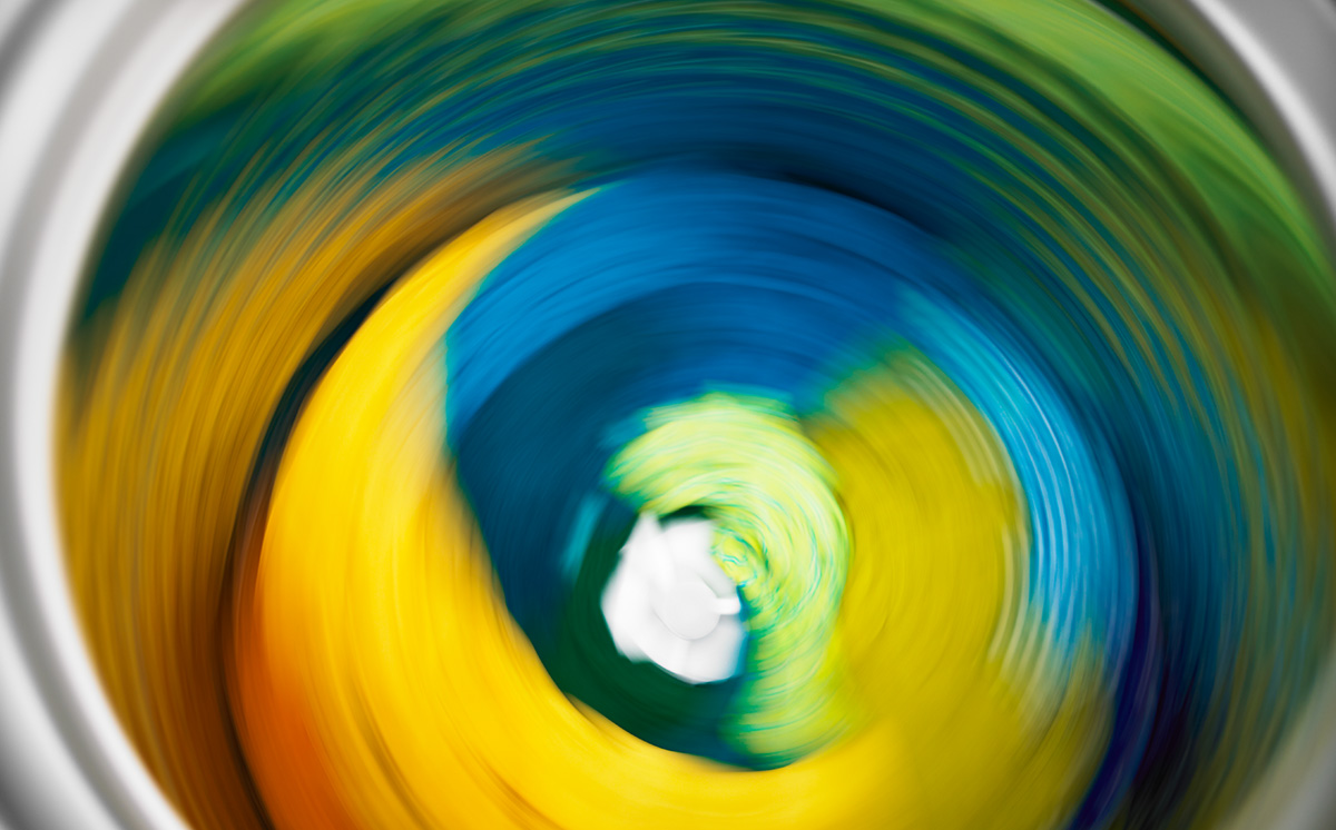 A load of colorful clothing going through a spin cycle. A load of colorful clothing going through a spin cycle.