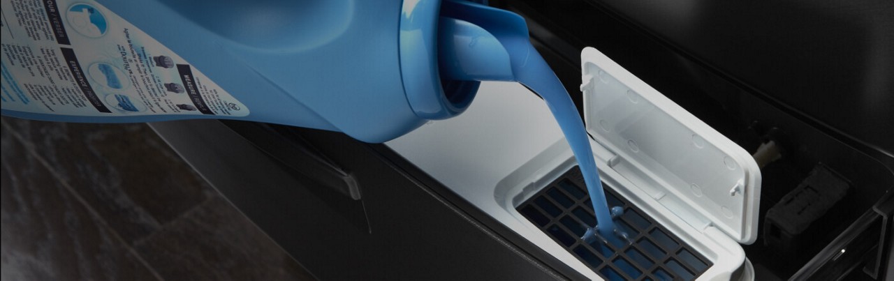Add detergent and fabric softener to the dispensers