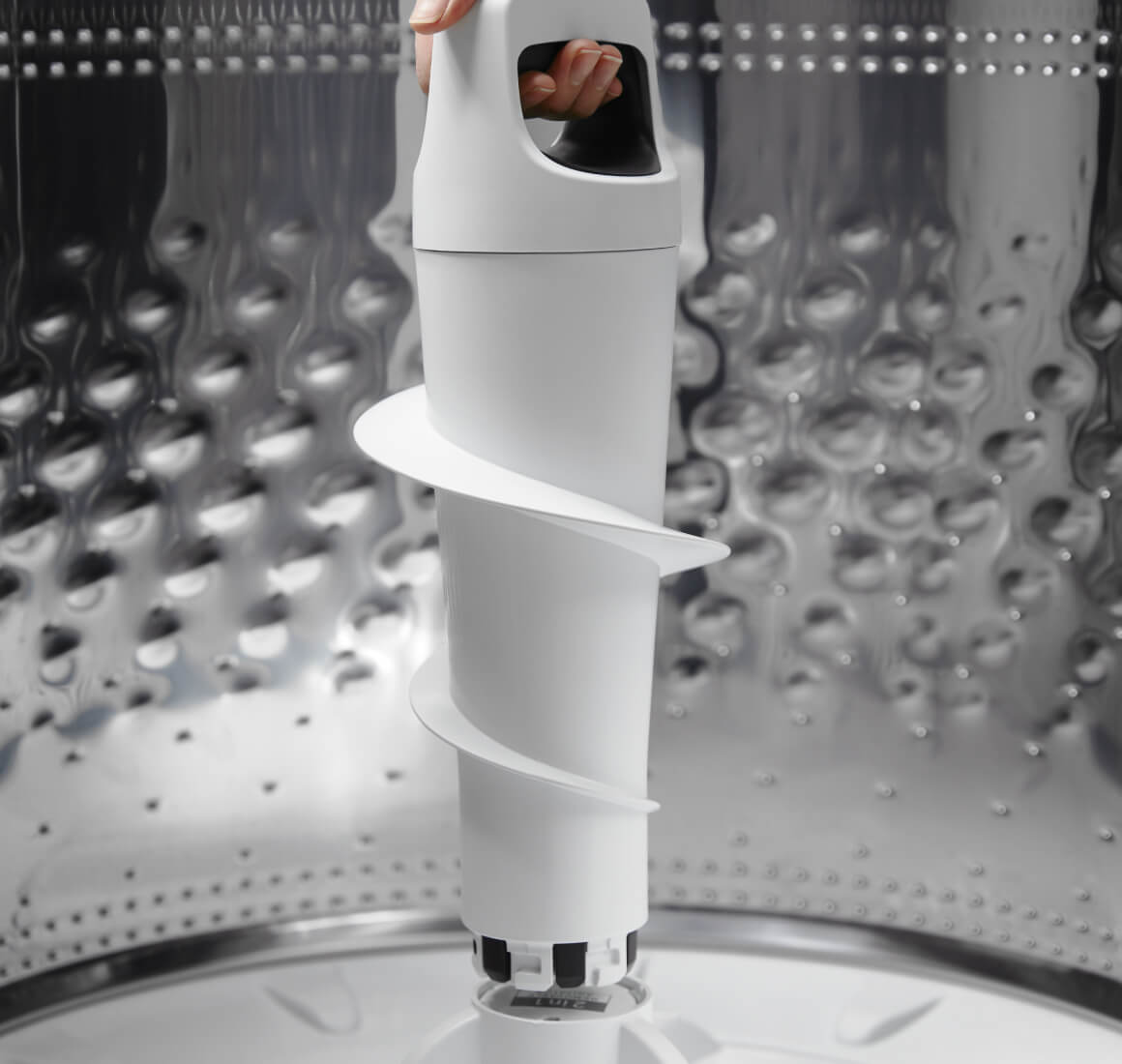 The 2 in 1 Removable Agitator being lifted out of a washer