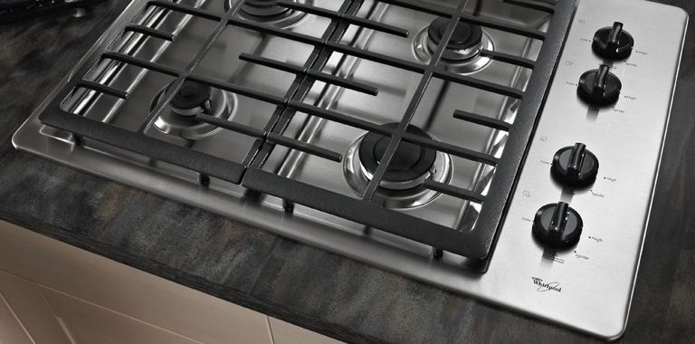 Whirlpool Gas Cooktop Installed On Black Marble Counter
