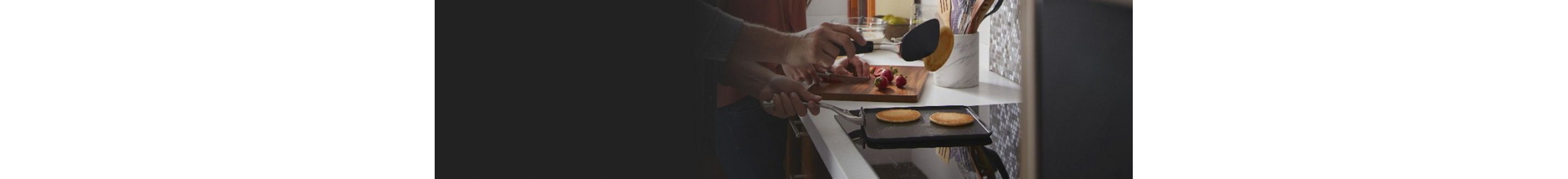 Pancakes being flipped over an induction cooktop