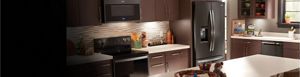 A sleek kitchen featuring a Whirlpool® stainless steel refrigerator.