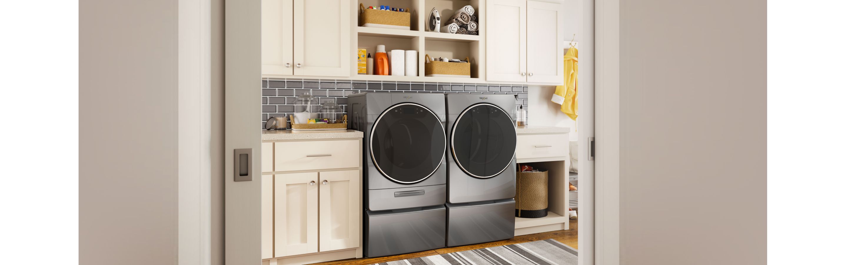 A Whirlpool washer and dryer in a modern laundry room.