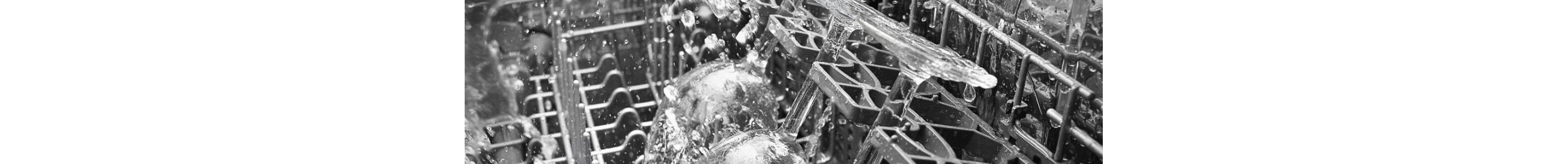 Inside a Whirlpool dishwasher that is in operation. Three glasses are being sprayed with water.