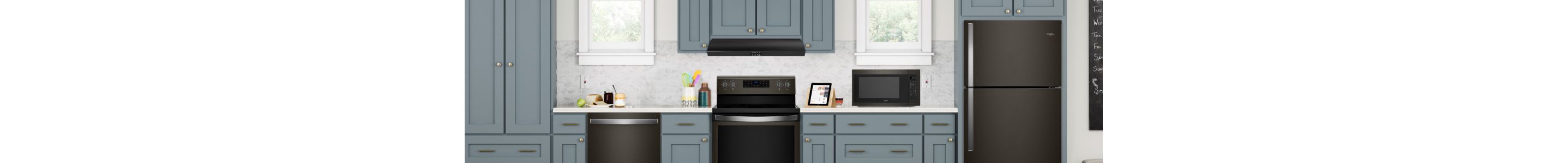A kitchen featuring black stainless steel Whirlpool appliances