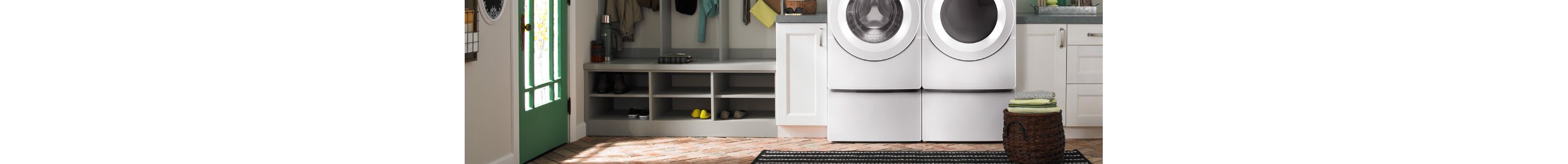 White front load washer and dryer on pedestals