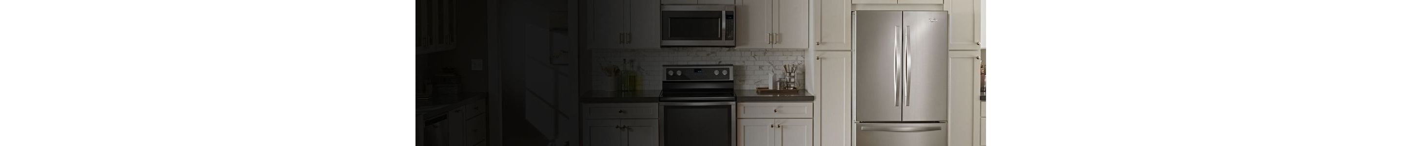 A modern kitchen featuring a stainless steel Whirlpool refrigerator, microwave, and range