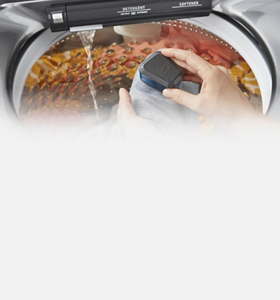 Person using the Whirlpool® Washer with Pretreat Station