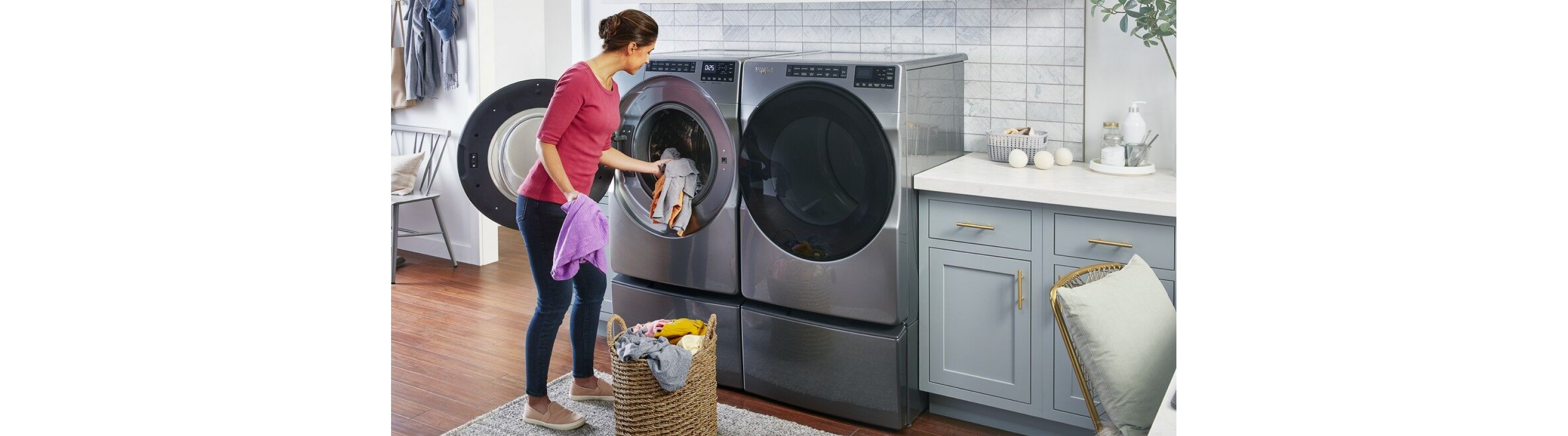 Person loading laundry in a Whirlpool® front load dryer