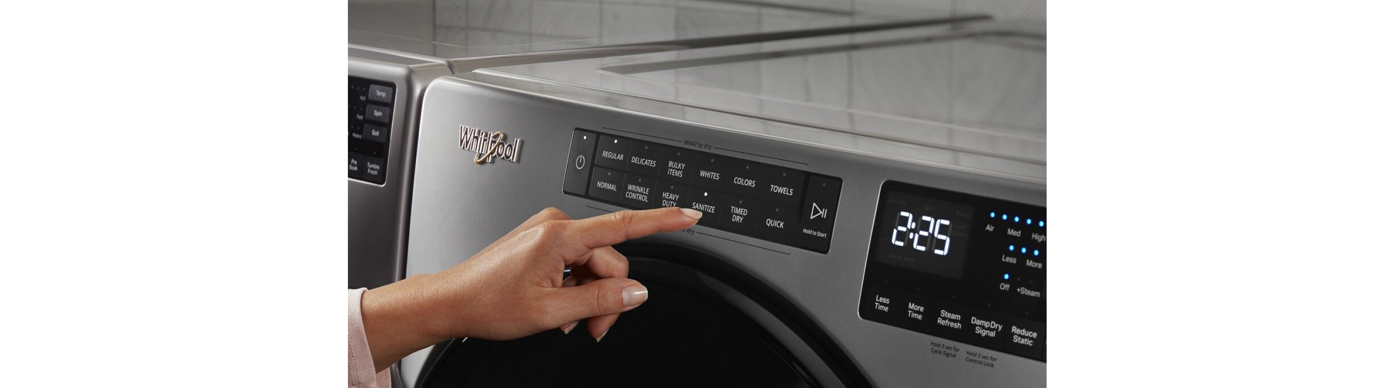 Person selecting a cycle on a Whirlpool® dryer