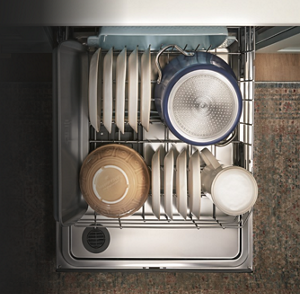 Open dishwasher filled with bowls and dishes